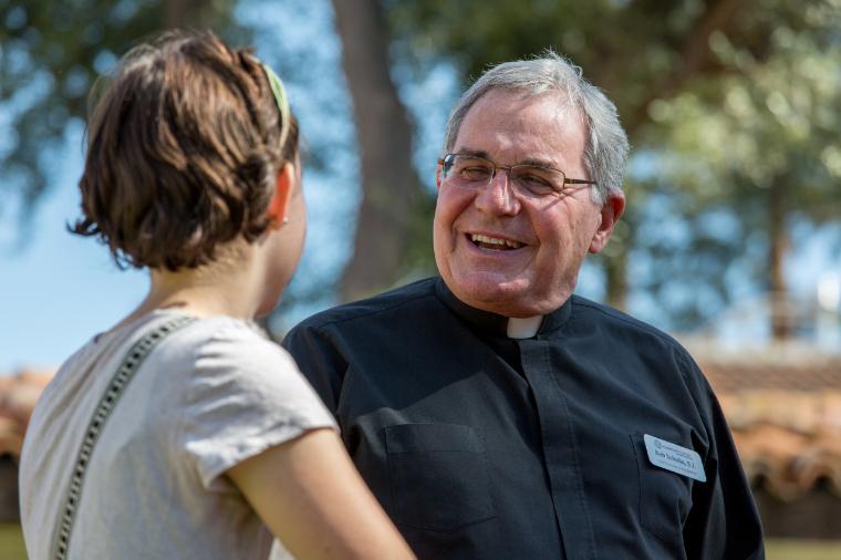 A Jesuit talking with a student