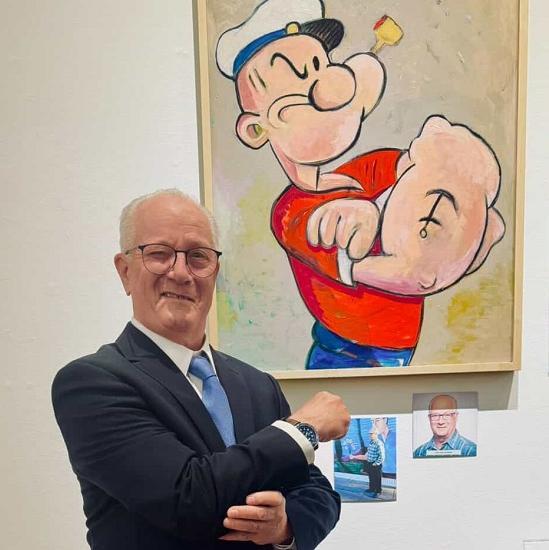 man standing in front of painting