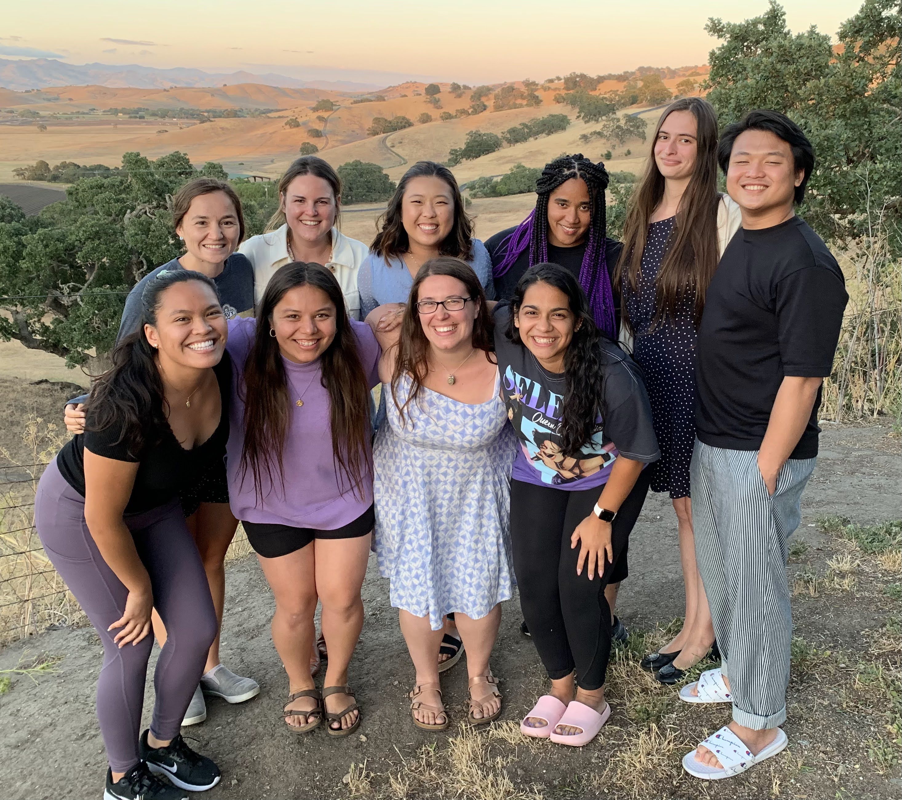 A group of people with smile on their faces looking at the camera image link to story