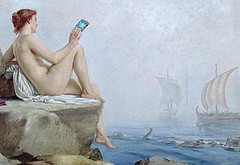 Woman sitting on cliff overlooking the sea