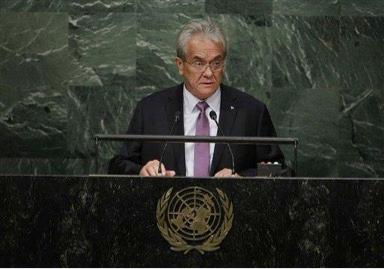 A person speaking at a podium with the United Nations emblem. image link to story