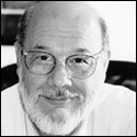 Black and white photo of a man wearing glasses. image link to story