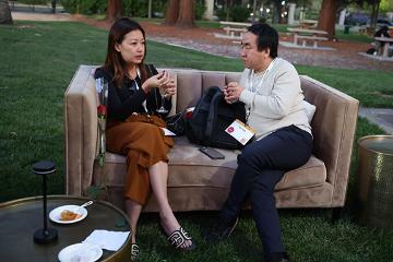 Woman and a man talking at Demo Day 2025 event