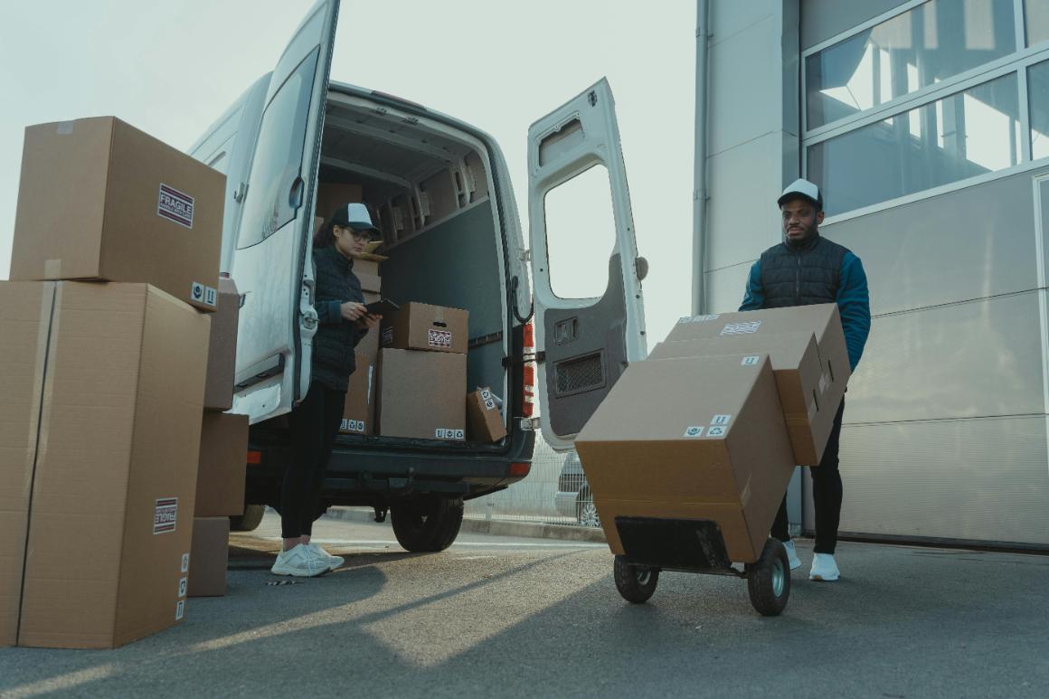 Boxes getting loaded into a sprinter van for delivery
