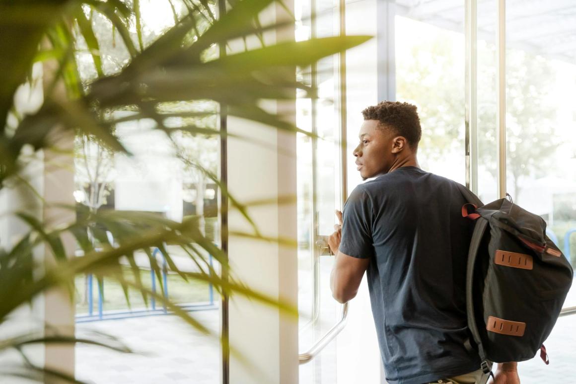 Student walking out of a campus building