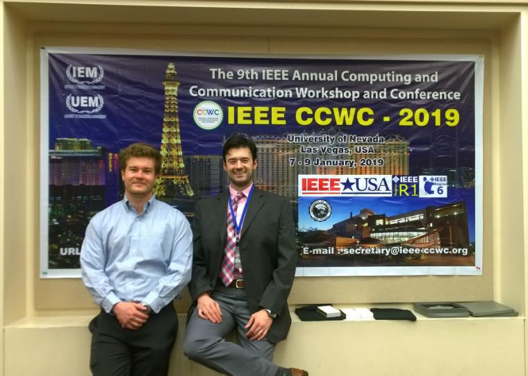 Two men smile in front of HA CCWC and sponsor logos.